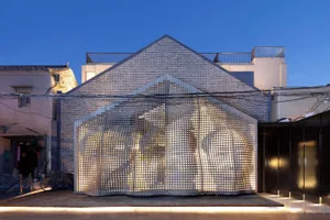 A modern retail space featuring a metallic perforated screen.