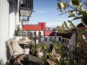A minimalist balcony featuring planters with greenery.