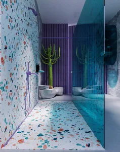 Modern bathroom featuring colorful terrazzo flooring and a purple shower head.