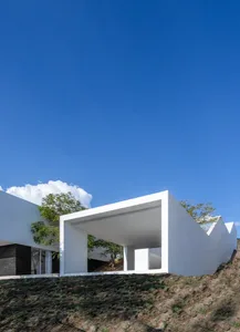 A modern house with concrete walls and a blurred background.