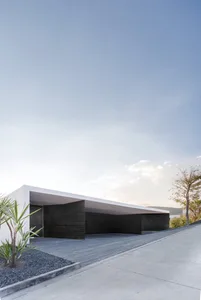 Modern minimalist house with white concrete roof, black architectural elements, and minimalist design.