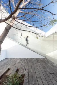 A minimalist interior design featuring glass and concrete materials.