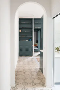 Minimalist interior design featuring a floor with a terrazzo pattern.