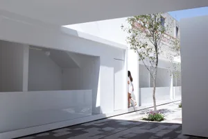 A minimalist white interior design with natural light, clean lines, and a serene atmosphere.