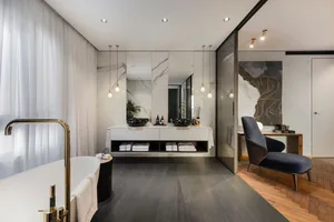 Modern bathroom with marbled floors, white marble walls, and a minimalist design.