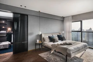 Modern bedroom featuring neutral materials and a stylish urban view.