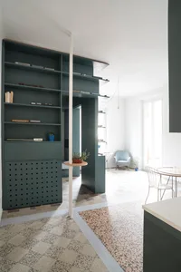 Modern home office featuring a concrete wall and floor, with a minimalist design.