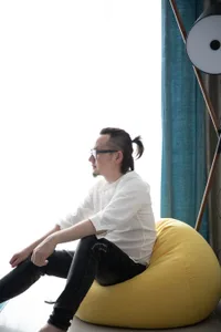 Person sitting on a yellow beanbag chair