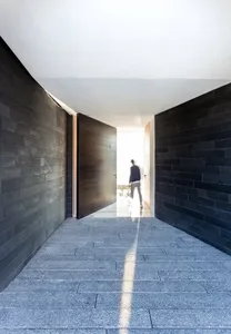A modern pathway with concrete flooring and walls.