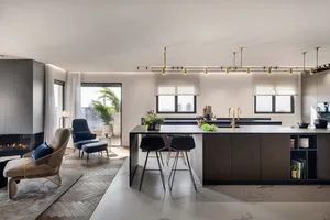 Contemporary kitchen interior with marble countertops, modern lighting, and minimalist design.