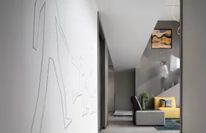A modern living room with concrete flooring, a yellow sofa, and a white wall with abstract art.