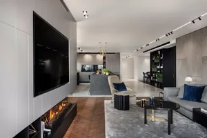 Modern living room with concrete tiles, minimalist furniture, and a fireplace.