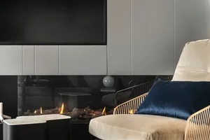 Modern living room featuring sleek, metal furnishings and glass surfaces.