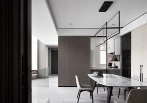 A modern kitchen-dining space featuring marble countertops and wooden accents.