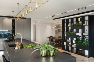 A modern residential kitchen and dining space featuring marble countertops in a sleek, contemporary design.
