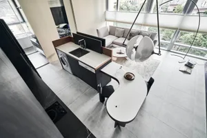 Modern apartment interior featuring concrete and glass materials.