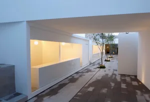 A modern interior design featuring concrete and glass materials.