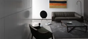 A modern living room with a minimalist sofa, coffee table, and abstract painting.