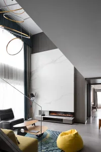 Modern living room with a marble fireplace and wooden coffee table.