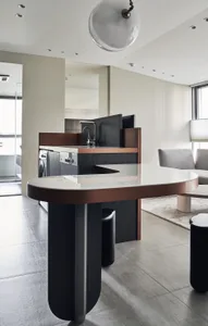Modern residential kitchen with marble countertops and metal accents