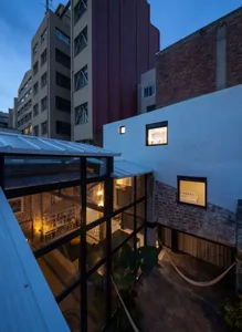 A renovated residential space with brick, concrete, and glass materials.