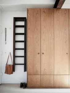 Modern, wooden wardrobe with sleek, stylish design and metal handles.