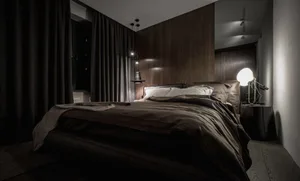 Industrial bedroom featuring dark textiles and minimalist design