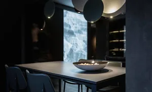 Minimalist dining table with metallic finish and abstract wall art