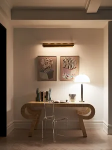 A modern work space featuring a transparent chair and wooden desk.
