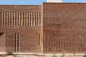 A brick wall with an intricate lattice pattern, featuring a combination of solid and open sections.