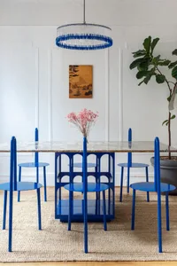 Blue dining room with marble table and blue chairs