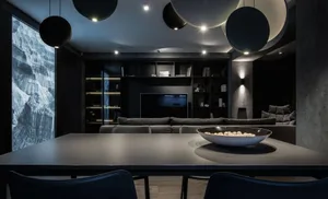 A modern living room with dark concrete flooring, minimalist furniture, and industrial-style lighting fixtures.