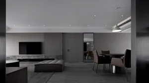 Modern living and dining area featuring dark metallic, wood, and marble materials.