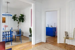 Modern interior design with white walls, wooden furniture, and concrete accents.