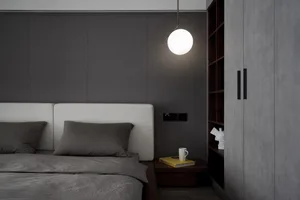 Minimalist bedroom featuring fabric headboard, wooden bed frame, and concrete wall