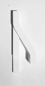 A white, abstract sculpture made of plaster, featuring smooth, curved lines and a minimalist design.