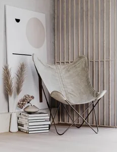 A minimalist lounge featuring neutral-color leather furnishings.