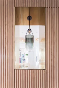 Modern interior design featuring a glass panel embedded in wood texture.