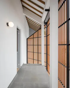 Modern interior corridor featuring wood and concrete materials.