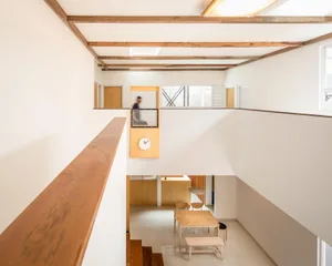 Minimalist living room featuring wood and concrete materials