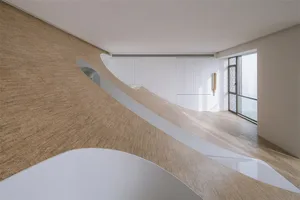 A photo of a modern residential space with a white wooden floor and minimalist design.