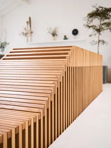 A row of modern, minimalist wooden furniture arranged in a staggered pattern, featuring clean lines and a neutral color palet