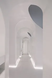 A minimalist corridor featuring glass and light design elements