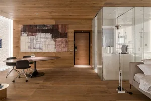 Modern bathroom interior with wooden flooring and minimalist design.
