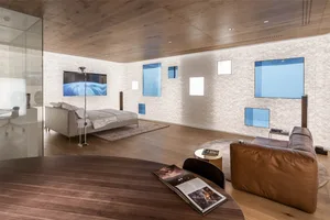 A minimalist living room with modern interior design, featuring contemporary furniture and natural lighting.