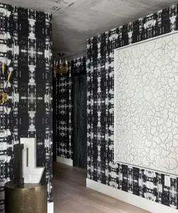 Modern, luxurious hallway featuring patterned wallpapers and a concrete finish.