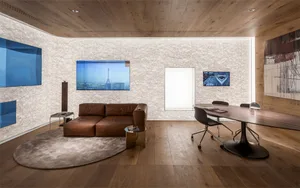 Modern office meeting space with a wooden floor, brown leather sofa, and white marble table.