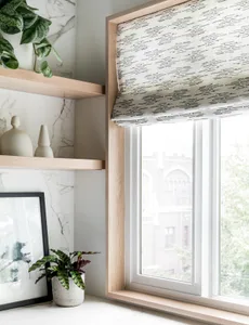 Modern interior with marble wall, window with greenery, and wooden shelves.