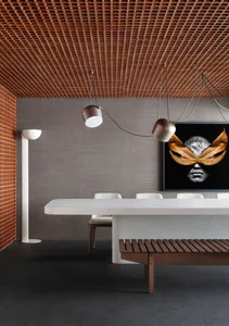 Modern dining room featuring a wooden table, concrete floors, and a wooden bench.