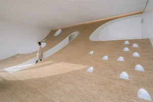 A modern interior with a cork floor and curved walls and steps